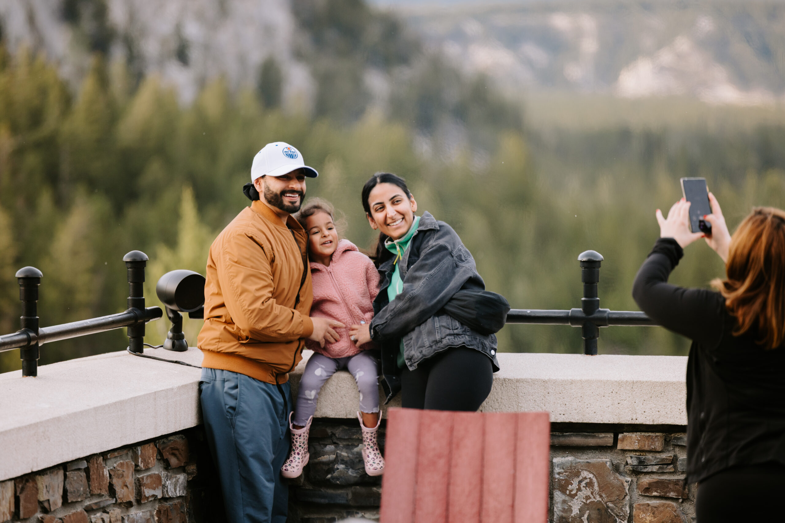 A family poses for a photo with a scenic mountain backdrop at the Fairmont Banff Springs hotel, the venue for the Alberta Dental Team Summit